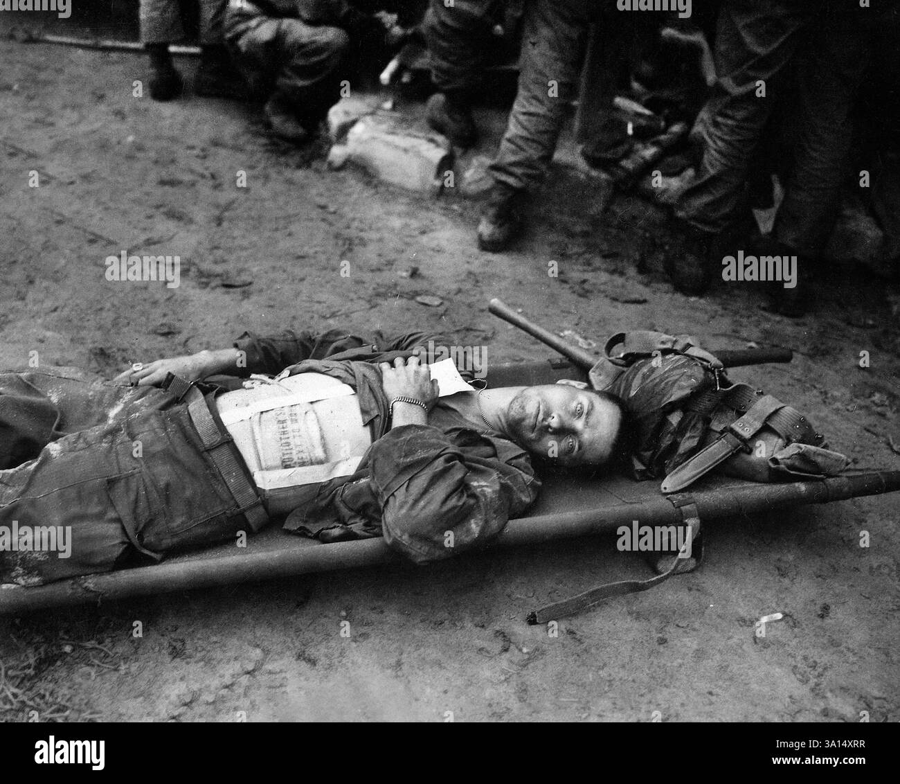 Private First Class, Thomas Conlon, 21st Infantry Regiment, laying on stretcher at medical aid station, after being wounded while crossing the Nakdong River, South Korea, U.S. Army Signal Corps, September 19, 1950 Stock Photo