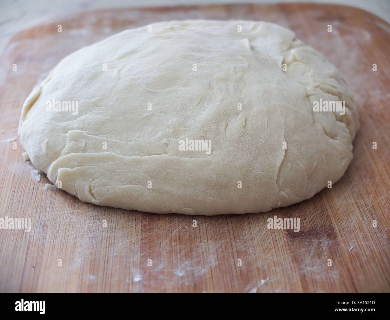 the baking dough is laid out on a board Stock Photo