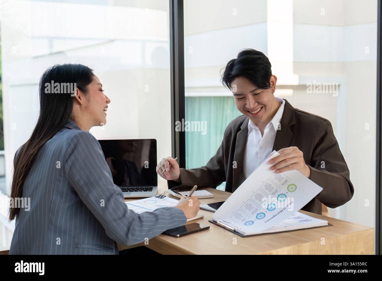 Dynamic teamwork. Professionals enjoying a collaborative session while discussing financial insights. Stock Photo