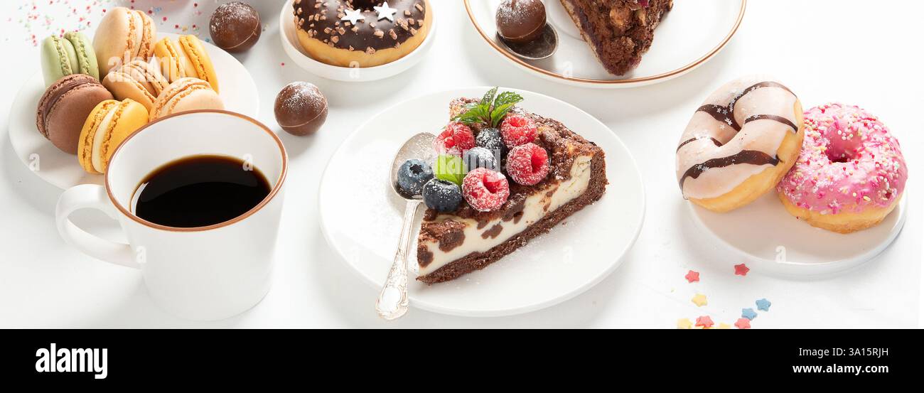 Table with various cookies, donuts, cakes, cheesecakes and coffee cup Stock Photo