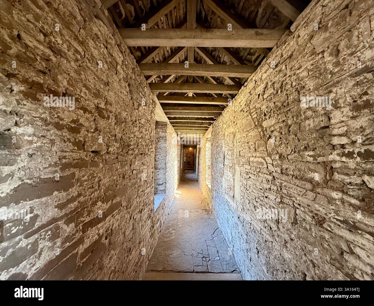 Long Stone Corridor with Wooden Ceiling and Beams within a Traditional Tudor Mansion - Smartphone Captured Stock Image