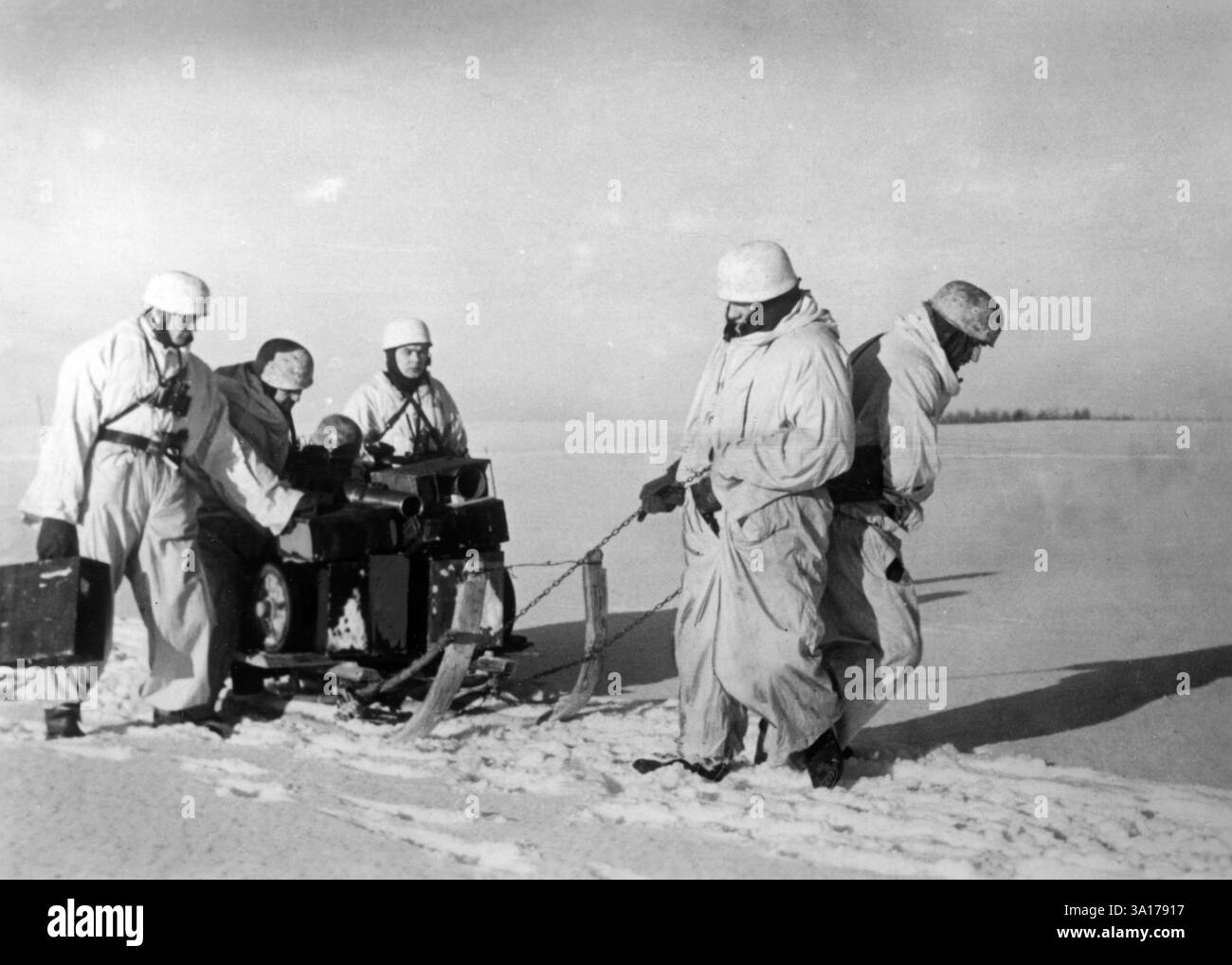 Paratroopers bring grenade launchers and ammunition forward on a sled ...