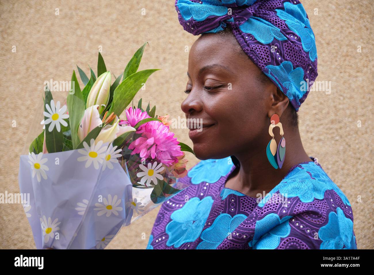 Woman smelling bouquet of flowers with closed eyes and smiling Stock ...