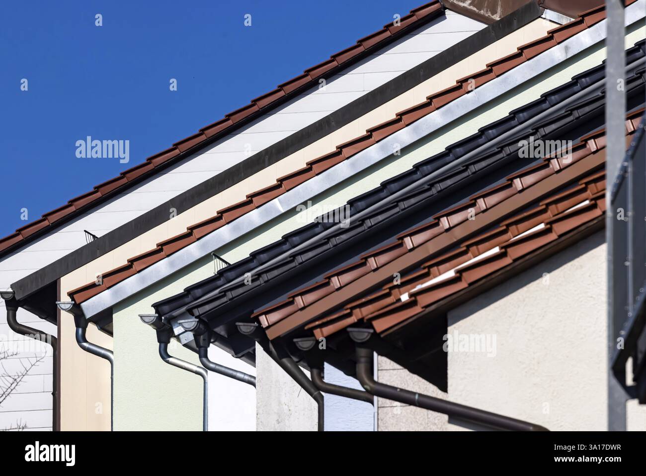 Terraced houses, architecture in series. Homes with pitched roofs and different roof coverings. Ulm, Baden-Wuerttemberg, Germany, Europe Stock Photo