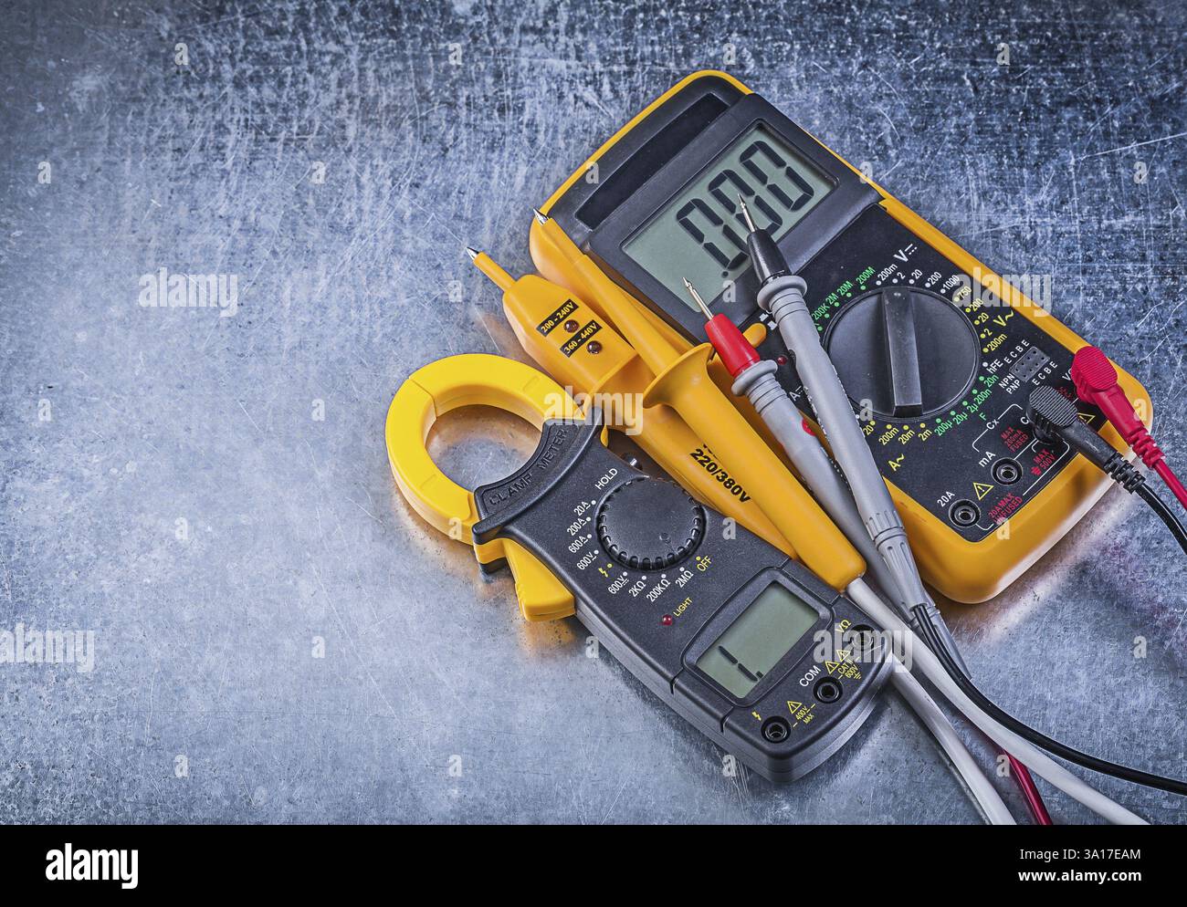 Digital clamp meter electric tester multimeter on metallic background Stock Photo