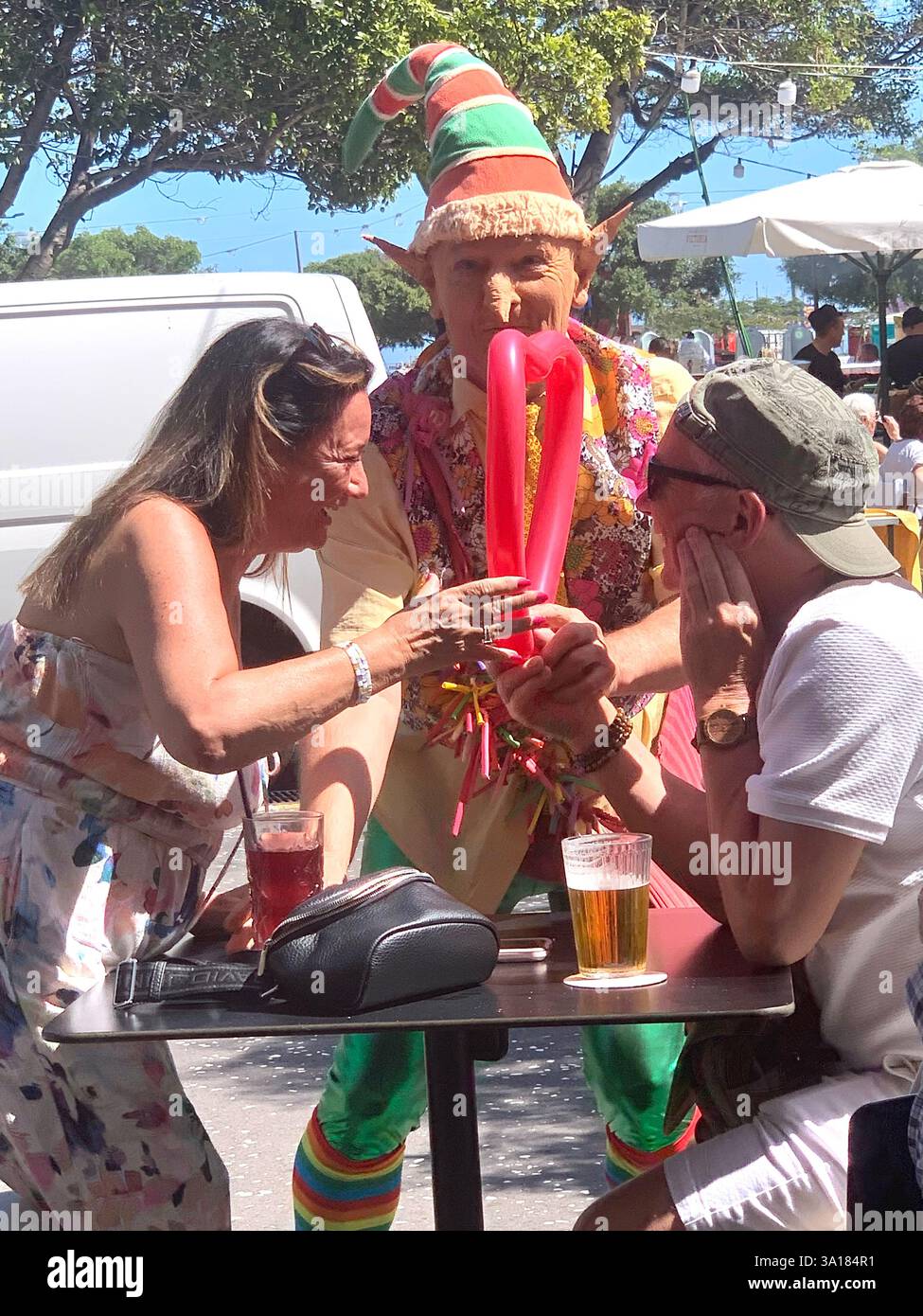 Carnival in Tenerife Canary Islands Spain man fancy dress heart shaped shapes balloons balloon hot sunny on holiday place beach  town local art work - Smartphone Captured Stock Image