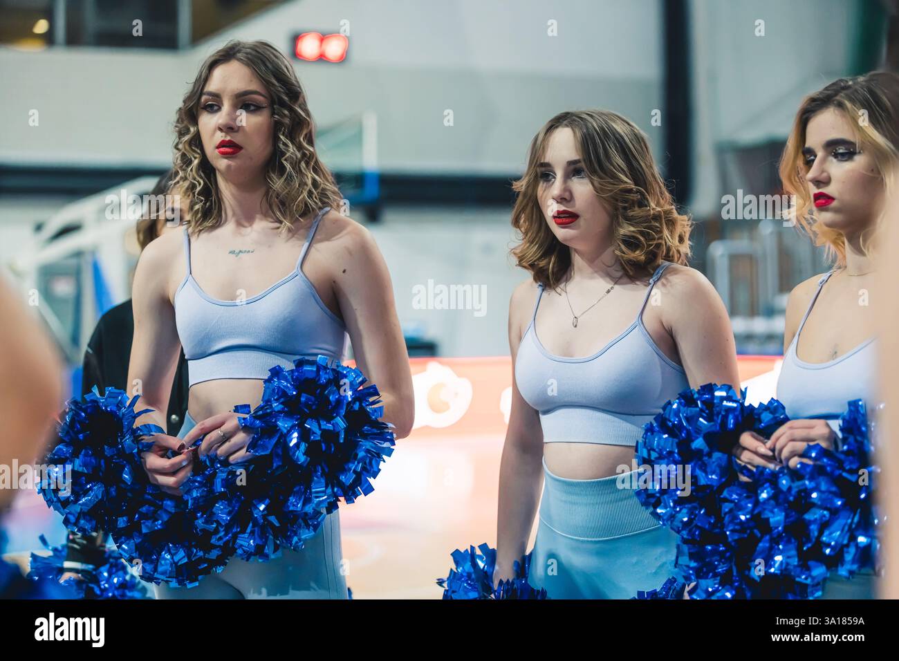 Cheerleaders Performing Dance Routine in Modern Sports Arena with ...