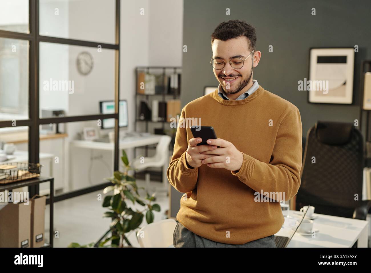 Man Using Phone in Office Stock Photo