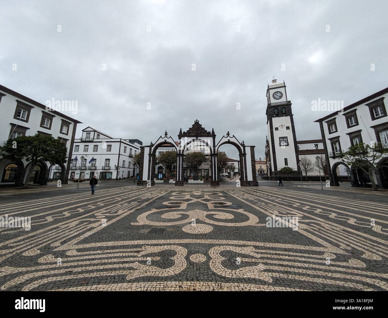 The City Gates of Ponta Delgada and São Sebastião Church in São Miguel, Azores, showcase historic basalt architecture, rich heritage, and island charm - Smartphone Captured Stock Image