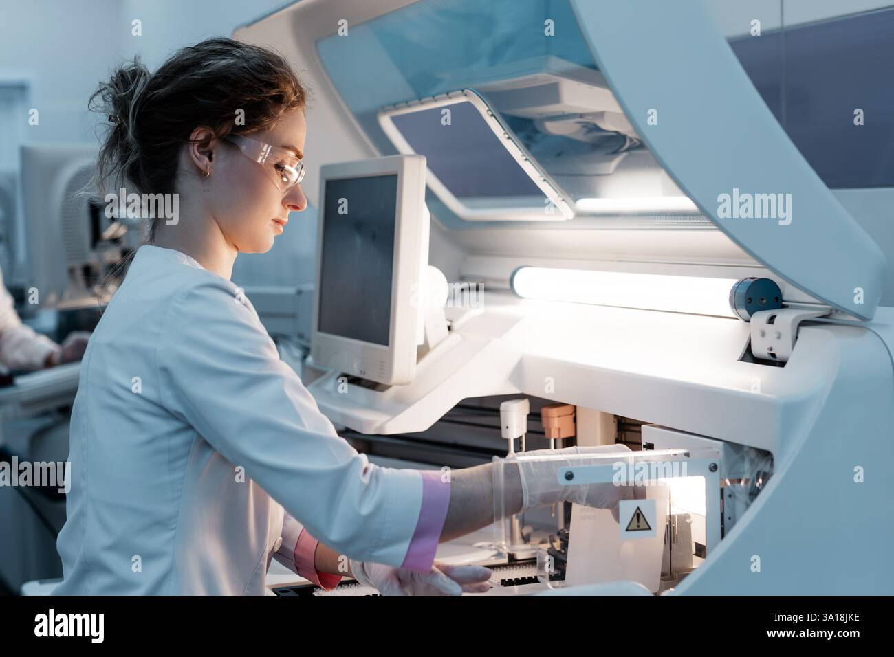 A scientist works with high-tech equipment in a modern laboratory ...