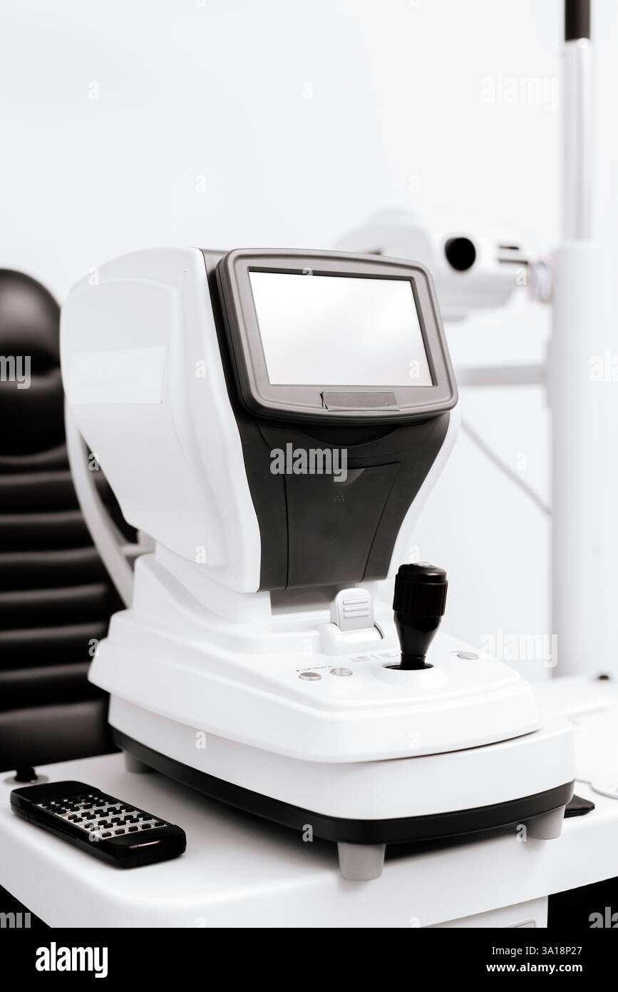 Close-up of a slit lamp against a white background in an ...