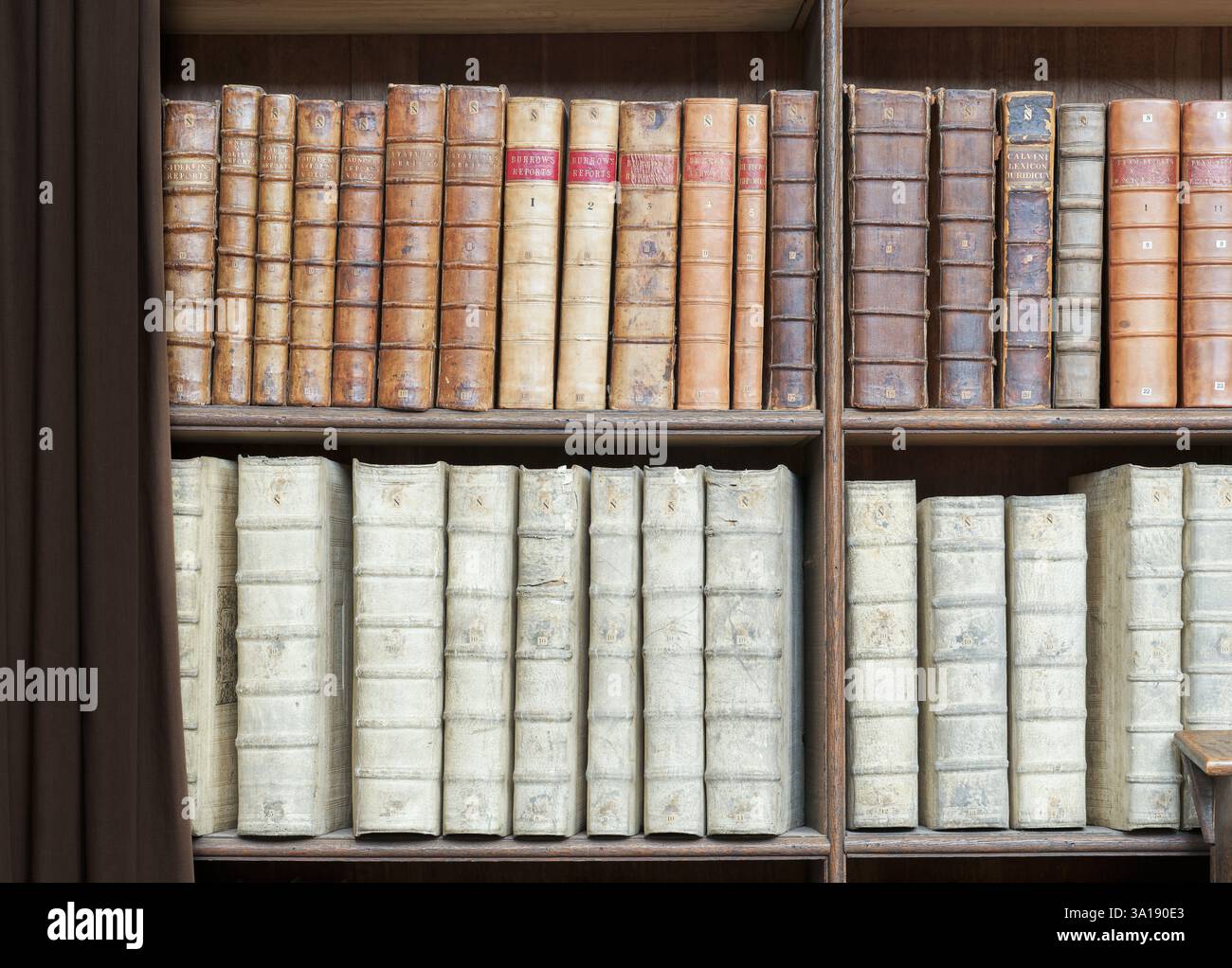 Leather bound books on shelves in the Wren library, Trinity College ...