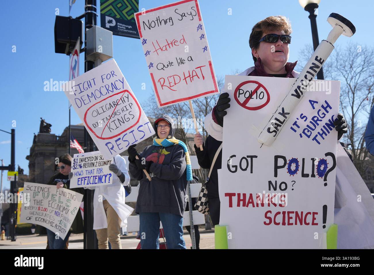 People hold signs during a Stand up for Science rally in Pittsburgh ...
