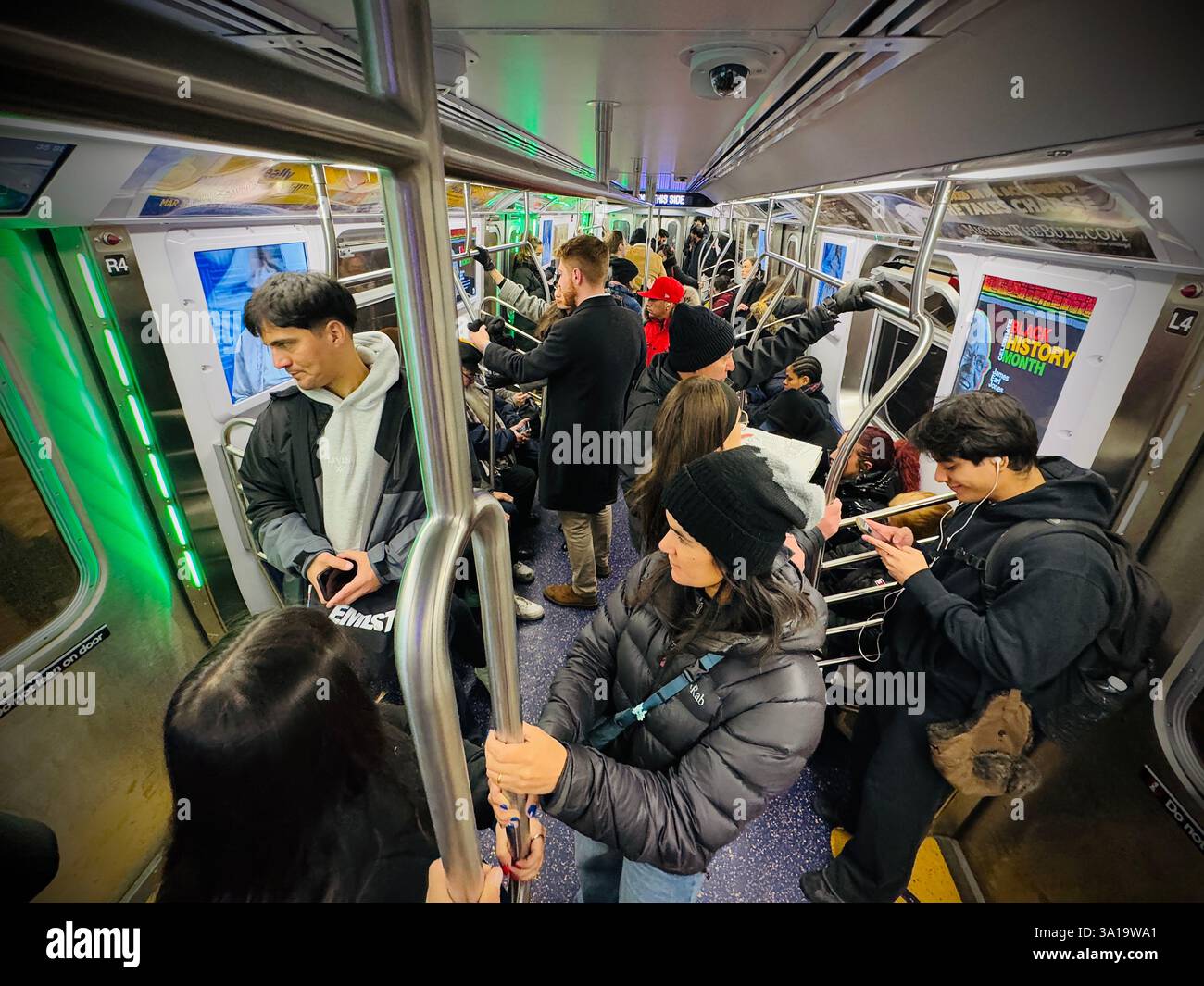 Unidentified people riding the nyc subway at night in new york city, NY - Smartphone Captured Stock Image