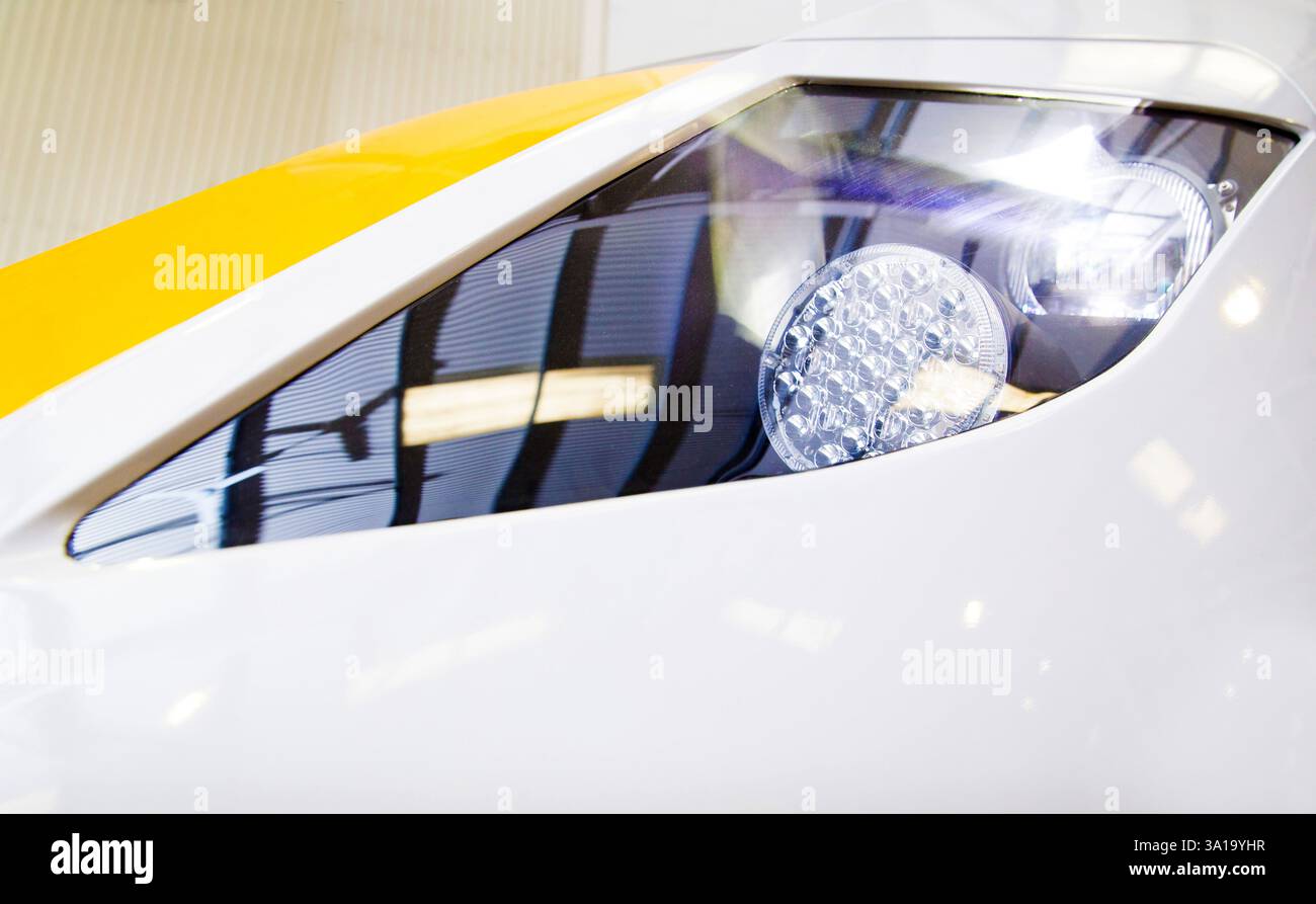 Close-up of a white train headlight, likely at a train depot ...