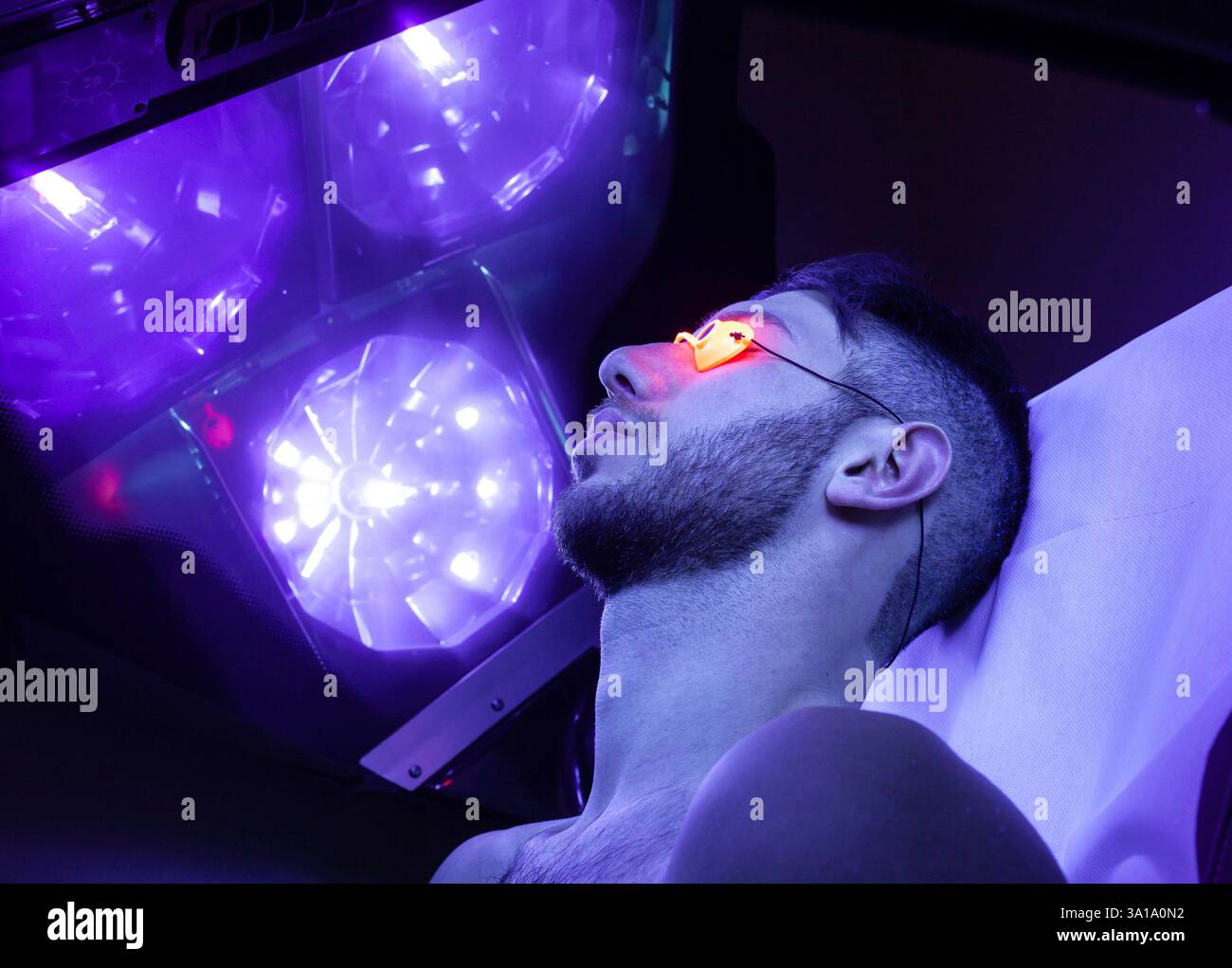 Young Thin Man At Solarium In Beauty Salon. Stock Photo