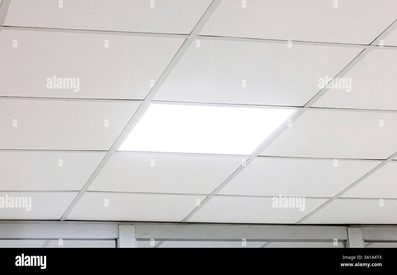 Modern design white office ceiling with led lighting. Stock Photo