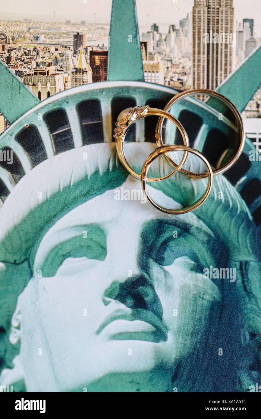 Wedding rings rest on the Statue of Liberty, symbolizing love against ...