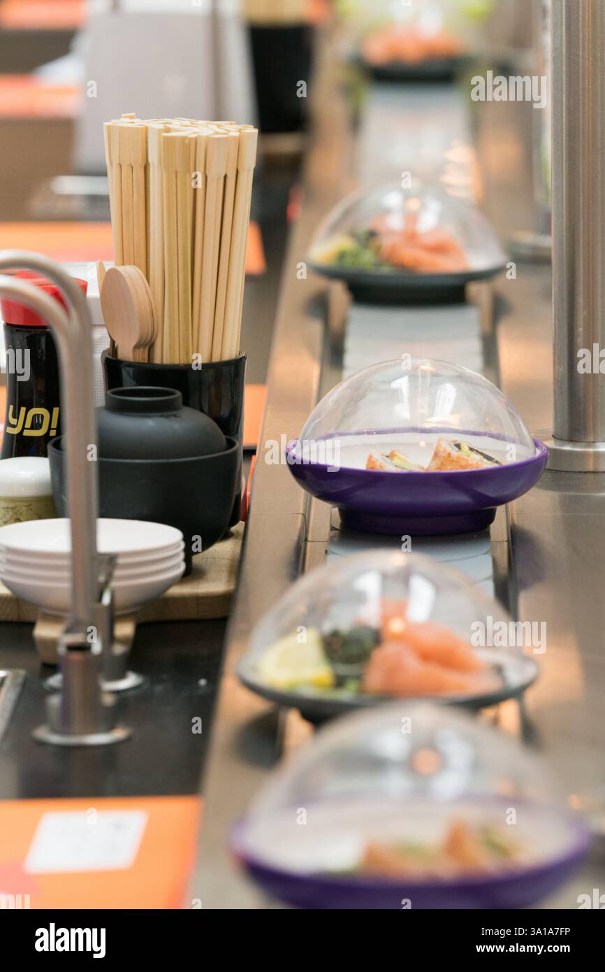 Sushi conveyor belt at a restaurant. Stock Photo
