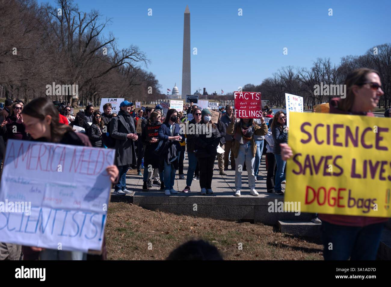 Demonstrators hold signs as they attend the Stand Up For Science rally ...