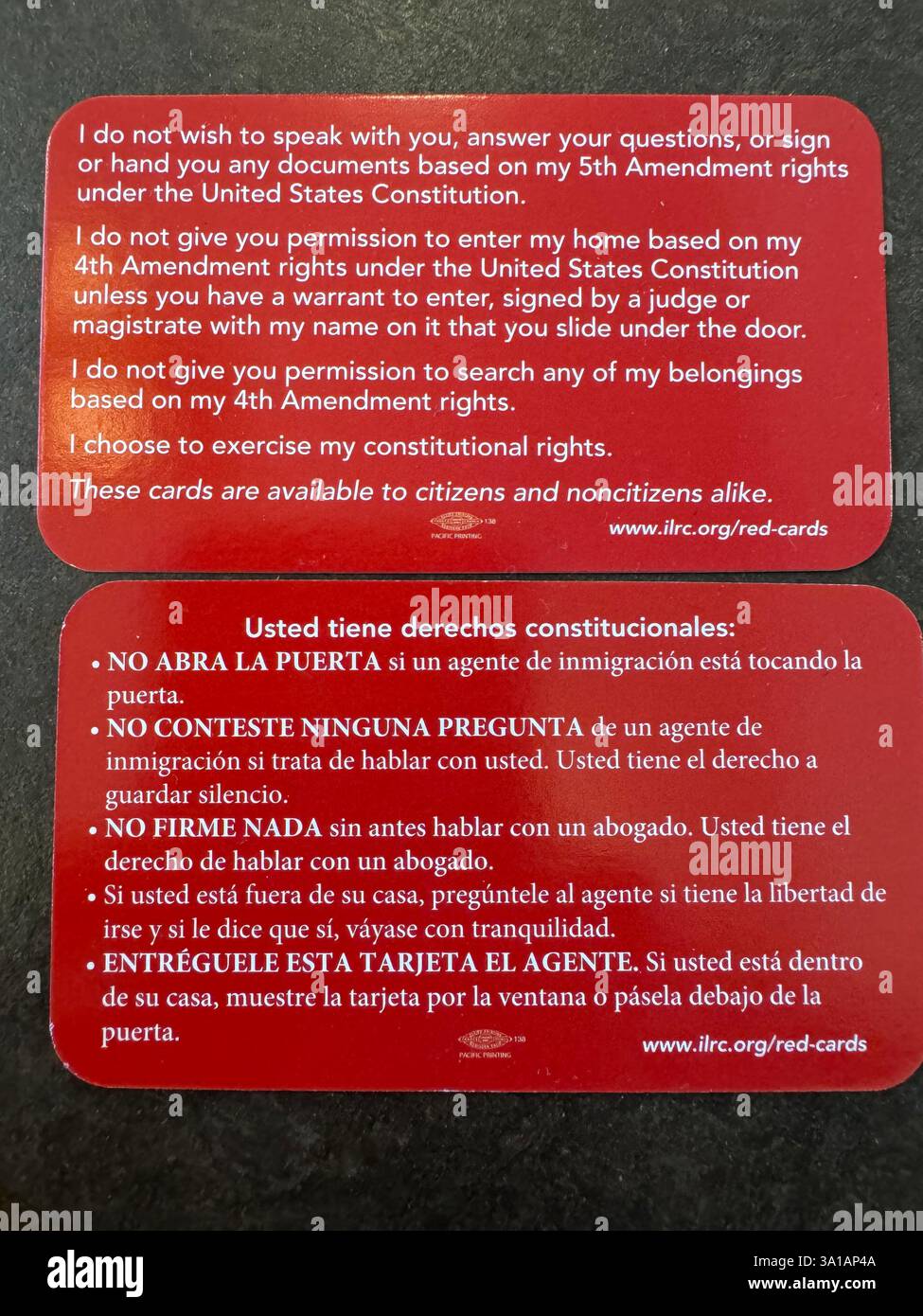 Red cards that give direction to immigrants on what to do if approached by ICE in the US. These are given out by Americans in protest to ICE activity. - Smartphone Captured Stock Image