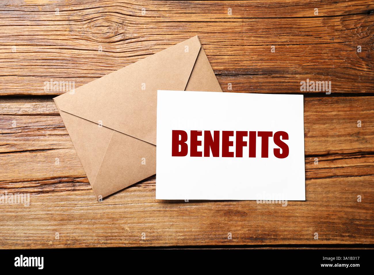 Letter with Benefits word and envelope on wooden table, top view Stock ...
