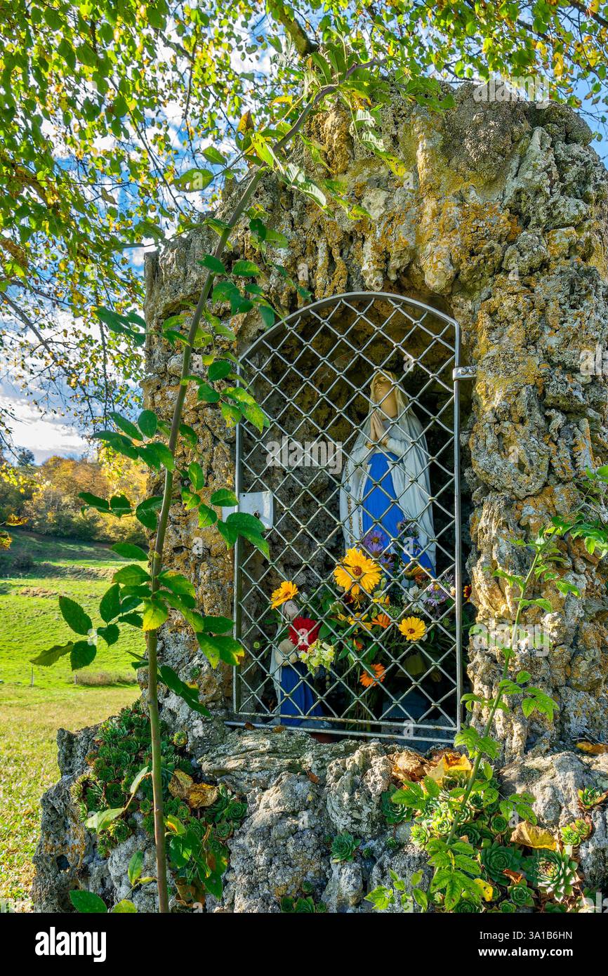 Münsingen - Bichishausen, The Lourdes Grotto in memory of the Mother of God apparitions of 1858 was built from tuff in 1890 and stands by the wayside near the Catholic parish church of St. Gallus Bichishausen. Stock Photo