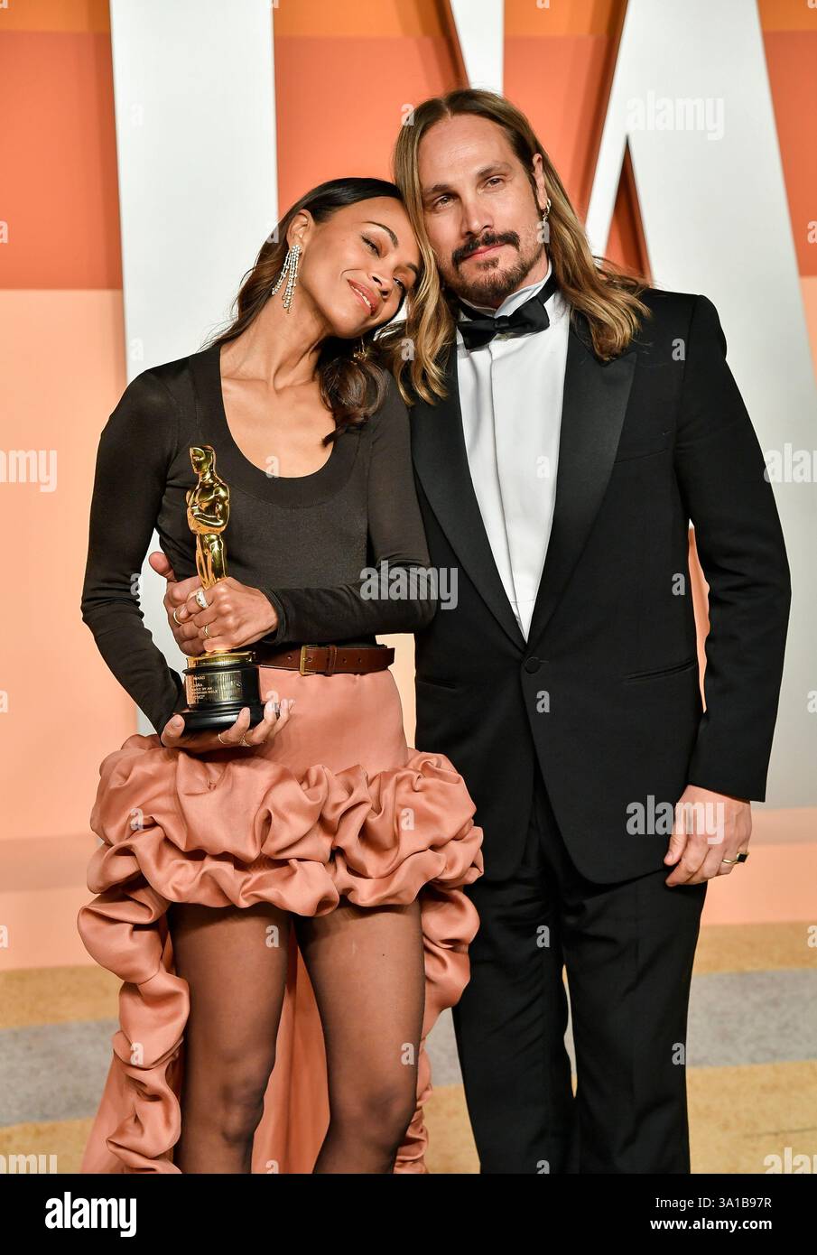 Zoe Saldana, left, and husband Marco Perego-Saldana arrive at the