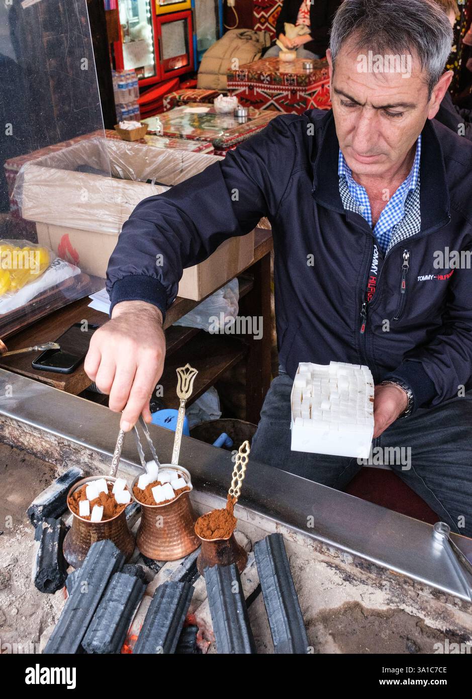 Istanbul, Turkey, Turkiye. Adding Sugar to Turkish Coffee. Stock Photo