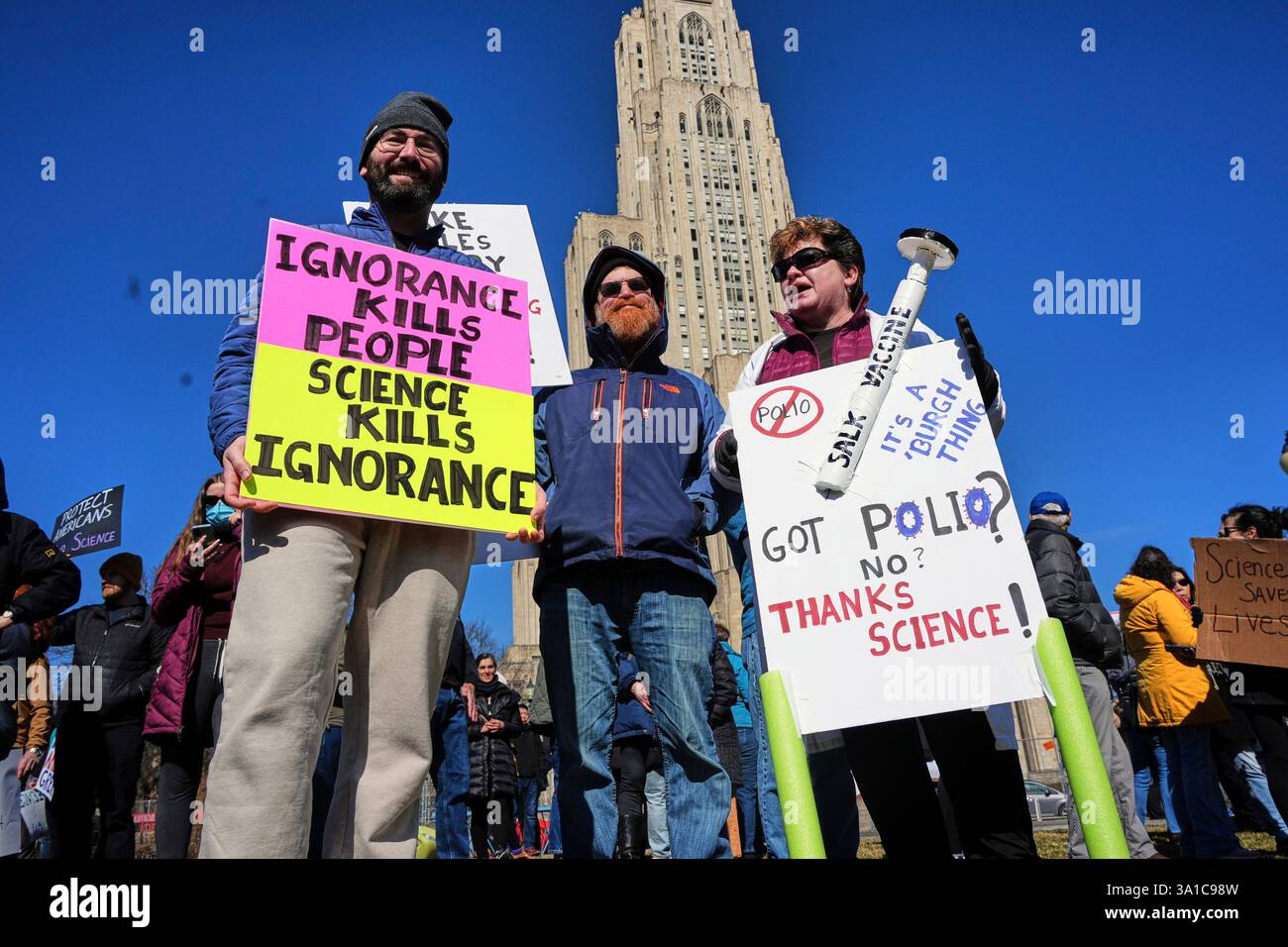 People hold a signs during a Stand up for Science rally on the ...