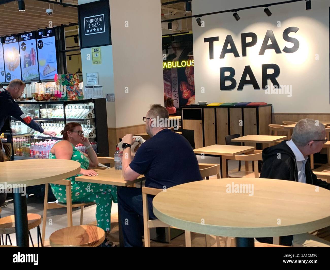 Tenerife Airport shop shopping food restaurant people sit sat floor waiting inside emergency exit flying hot food beer drink signs sign baggage glass - Smartphone Captured Stock Image