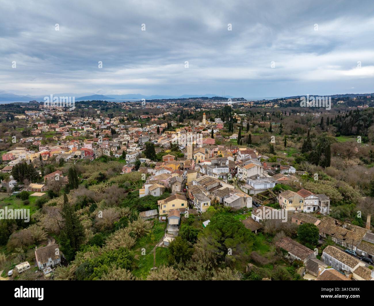 Aerial view showcases a quaint village with a church tower nestled ...