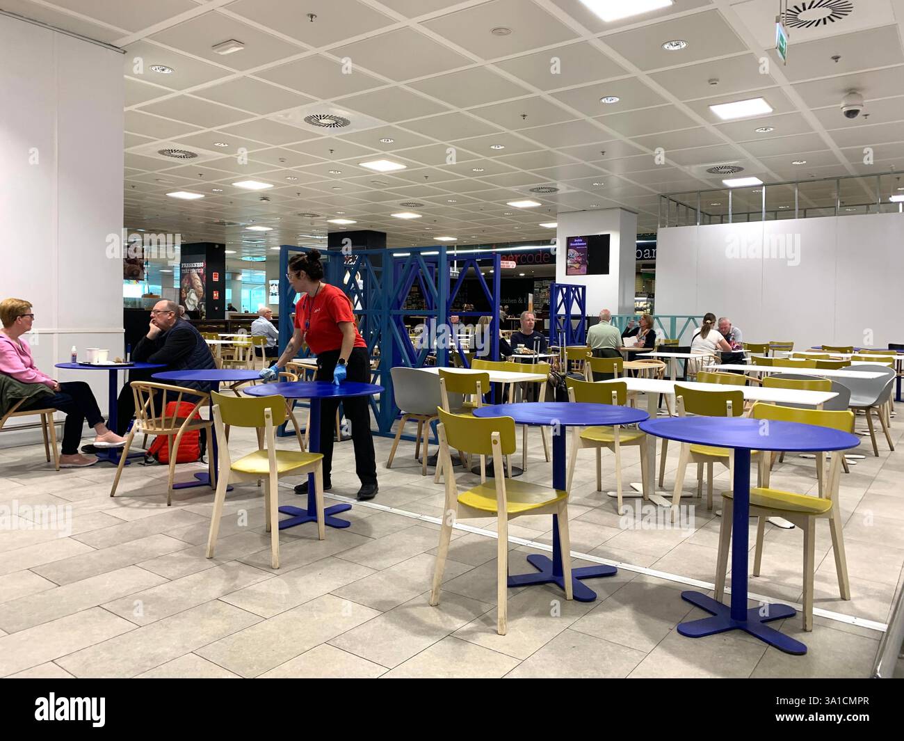 Tenerife Airport shop shopping food restaurant people sit sat floor waiting van emergency exit flying hot food beer drink signs sign VW Volkswagen - Smartphone Captured Stock Image