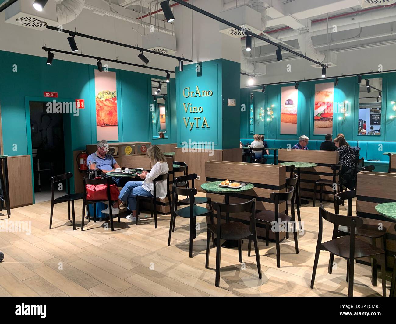 Tenerife Airport shop shopping food restaurant people sit sat floor waiting inside emergency exit flying hot food beer drink signs sign baggage glass - Smartphone Captured Stock Image