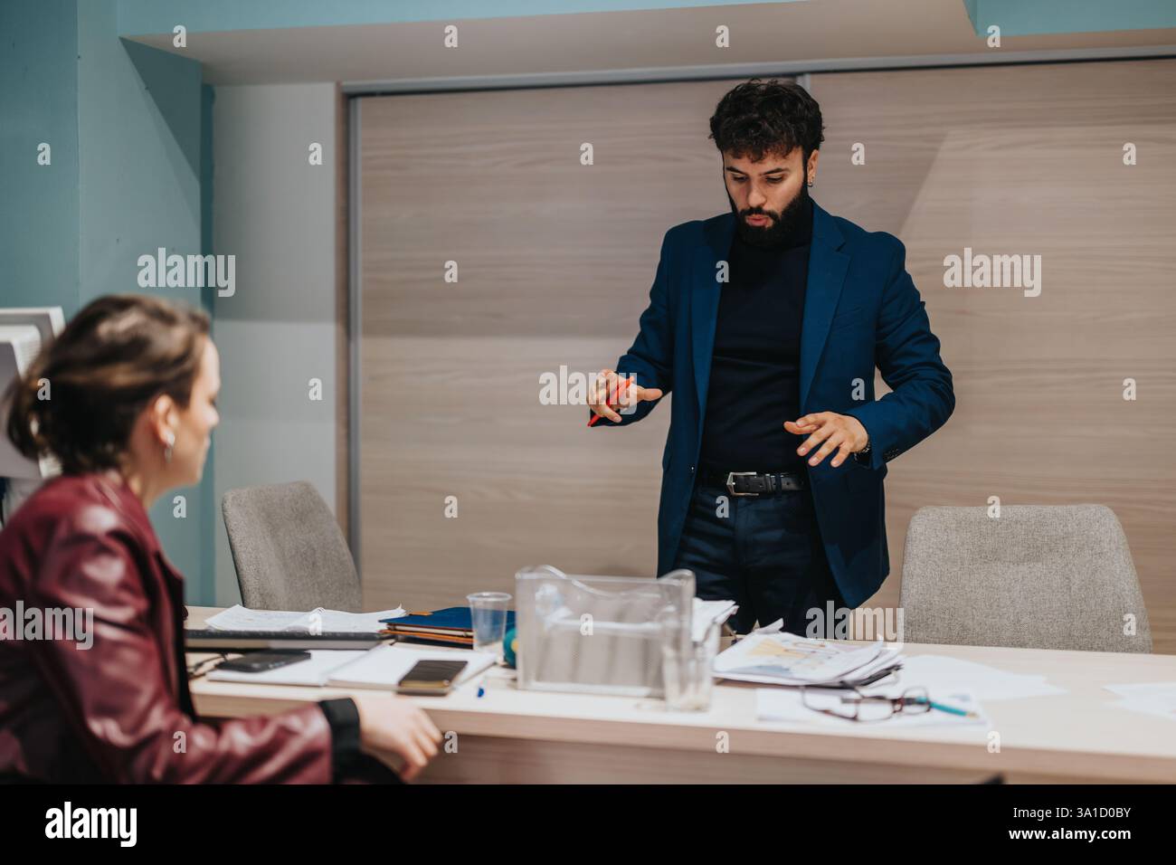Professional discussion between colleagues in a modern office setting Stock Photo