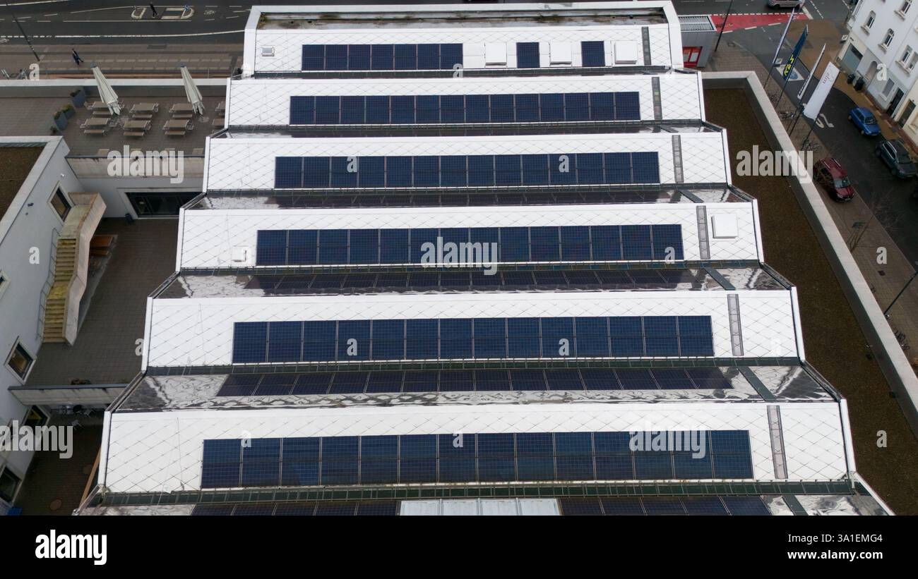 Urban Development Rooftops Top-down view of a large rooftop covered with solar panels ...