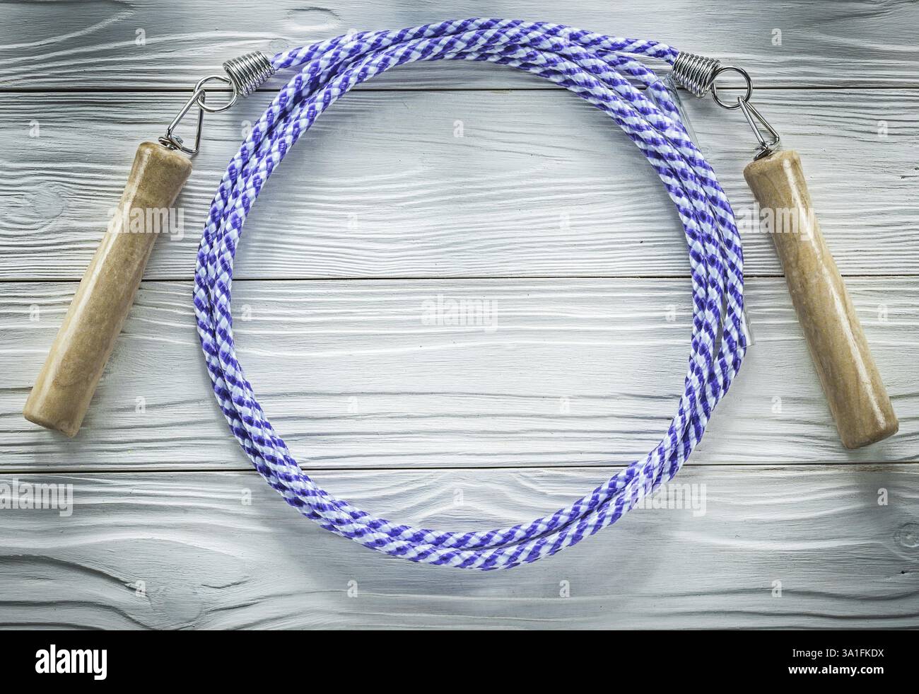 Jumping rope with wooden handles on wood board sports training concept ...