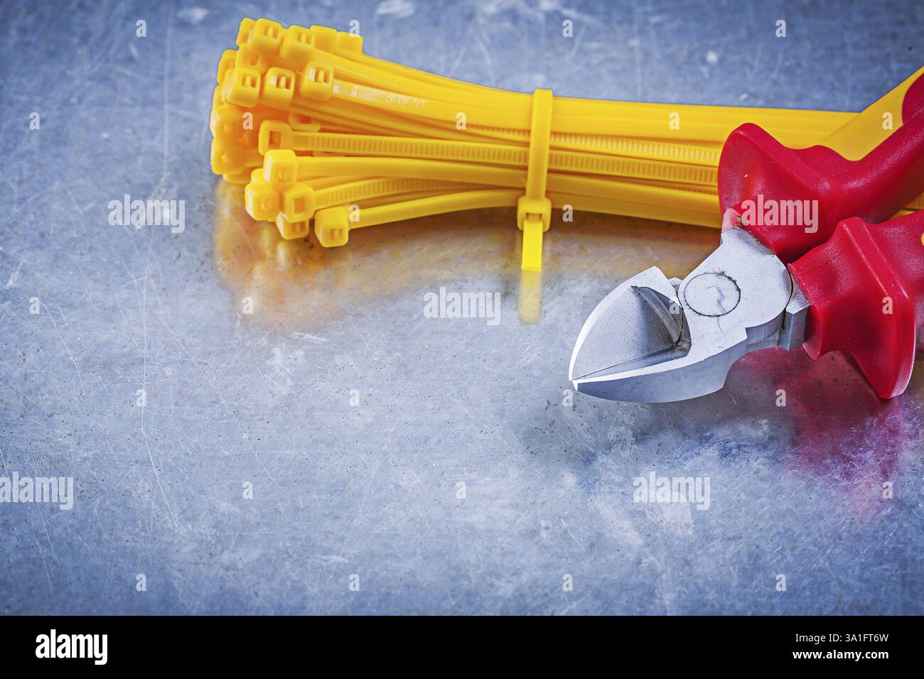 Nippers cable ties on metallic background construction concept Stock Photo