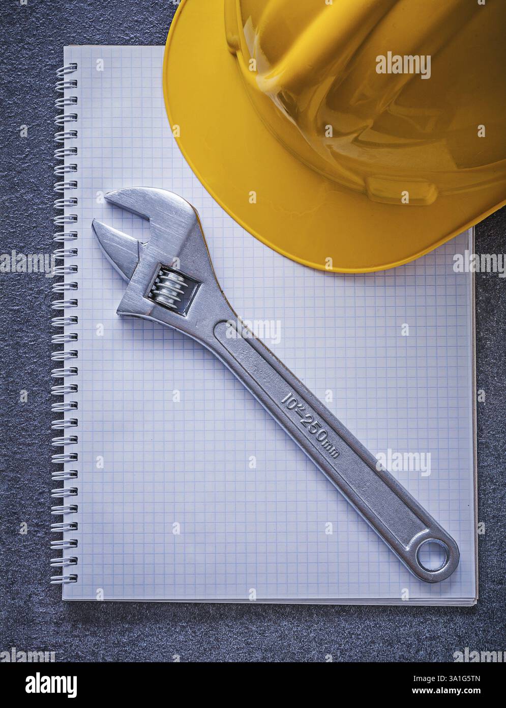 Notebook hard hat adjustable spanner construction concept Stock Photo