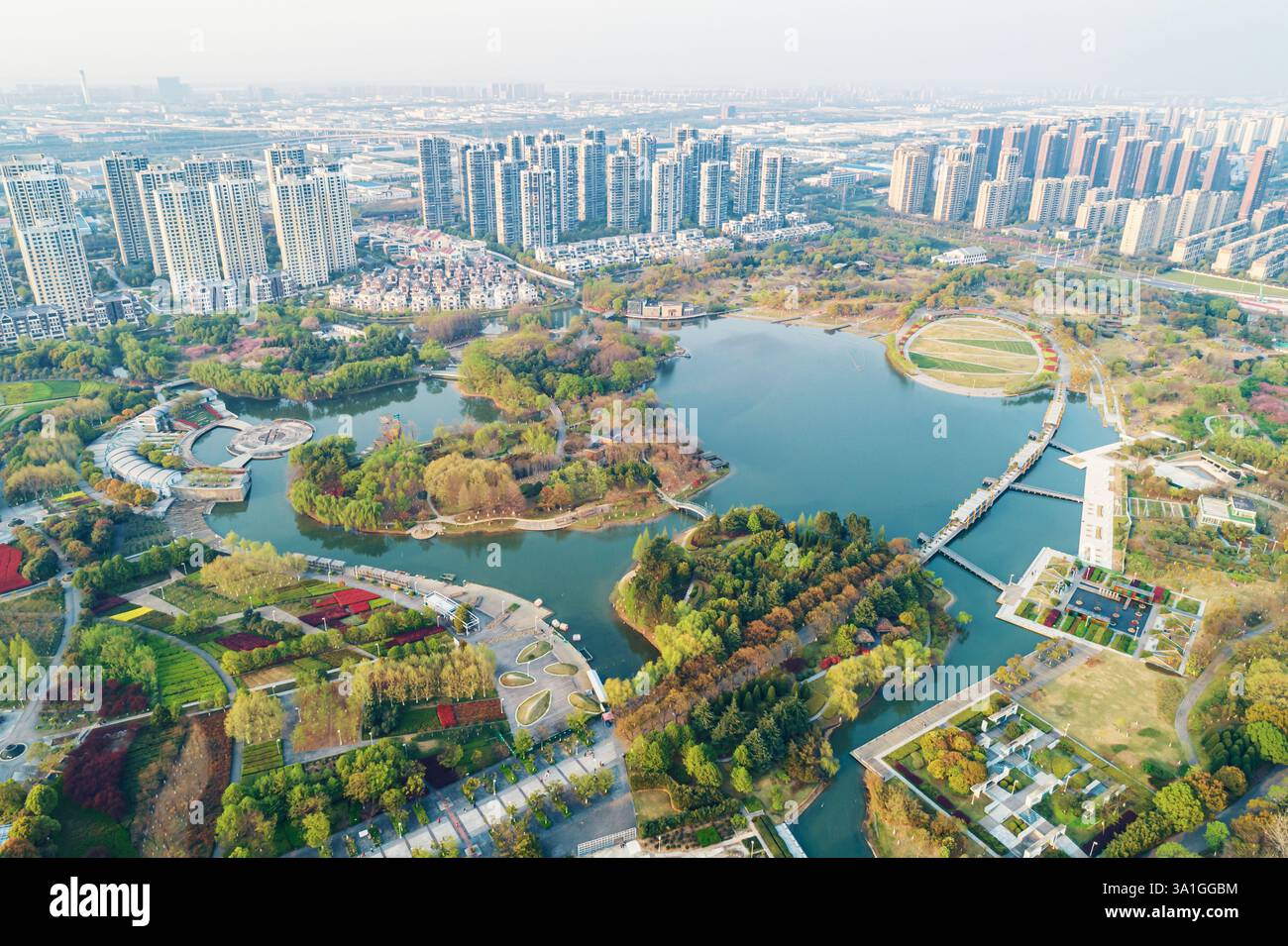 Aerial view of a lush urban park featuring water bodies and pathways ...