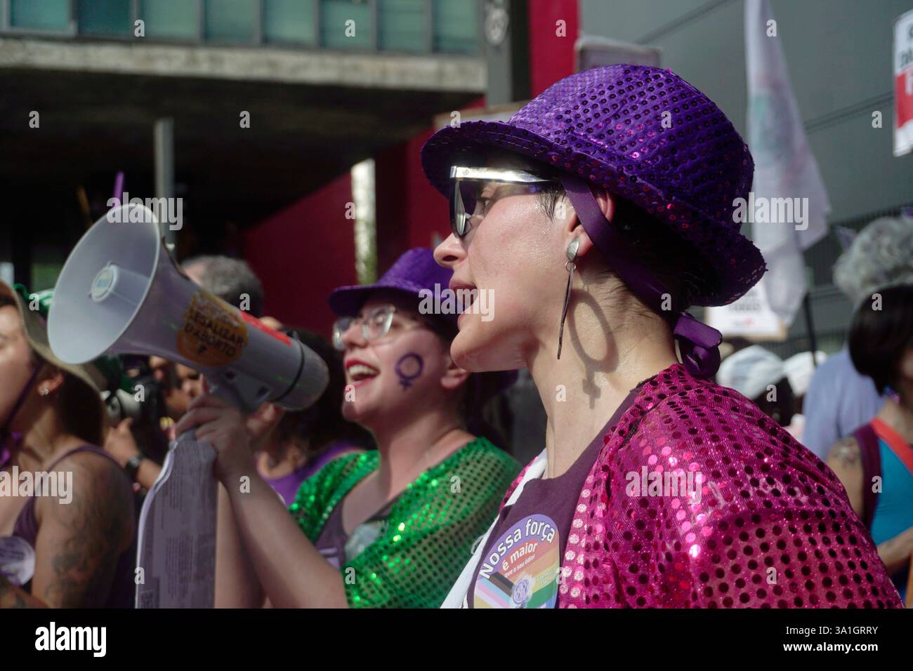 Women take part in a march to mark International Women's Day in Sao