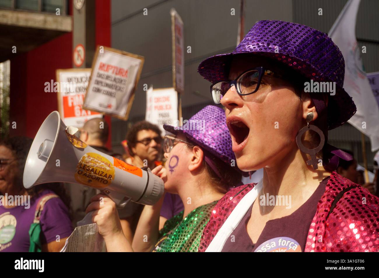 Women take part in a march to mark International Women's Day in Sao