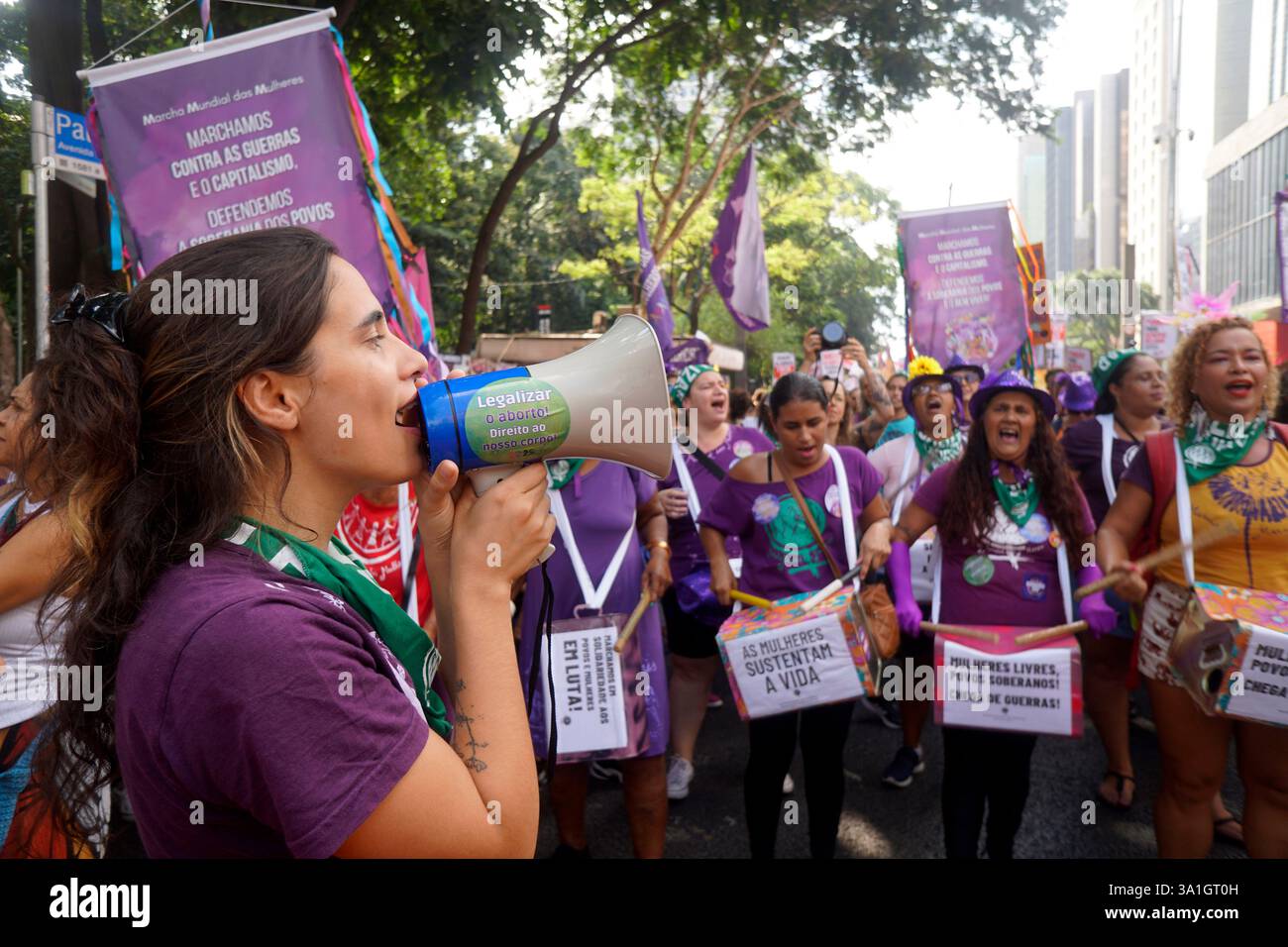 Women take part in a march to mark International Women's Day in Sao