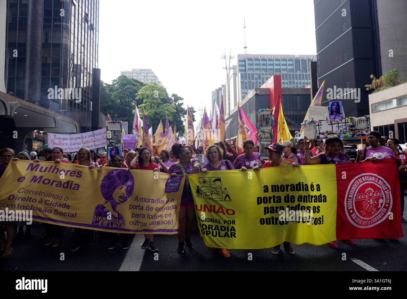 Women take part in a march to mark International Women's Day in Sao