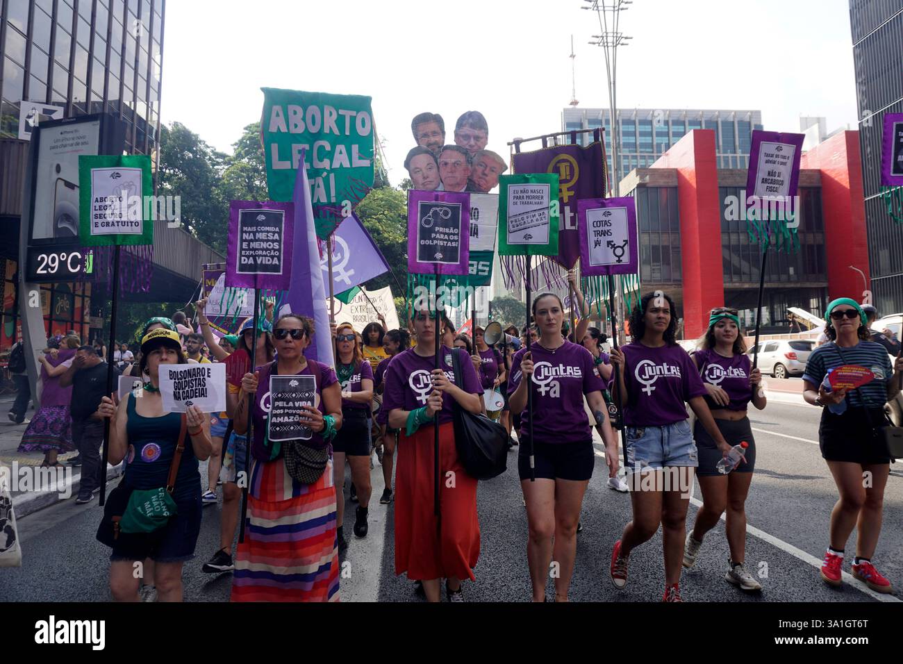 Women take part in a march to mark International Women's Day in Sao