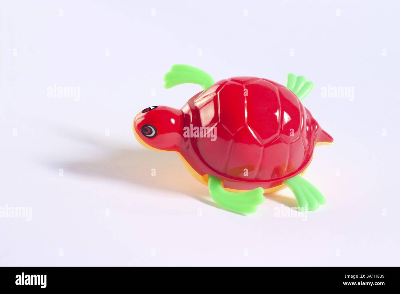 Concept, plastic toy tortoise on white background Stock Photo - Alamy