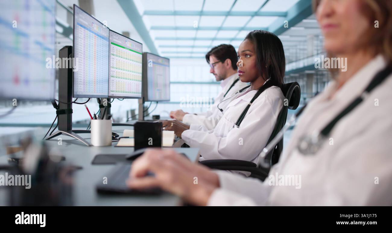 Multiracial Medical Team Manages Billing Codes Using Online Spreadsheets Stock Photo