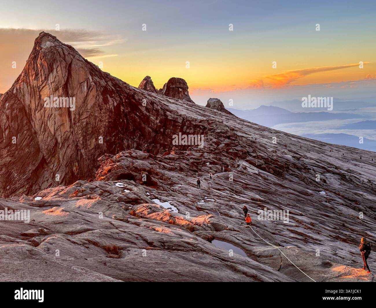 Climbers nearing the summit of Mount Kinabalu in Borneo at sunrise - Smartphone Captured Stock Image