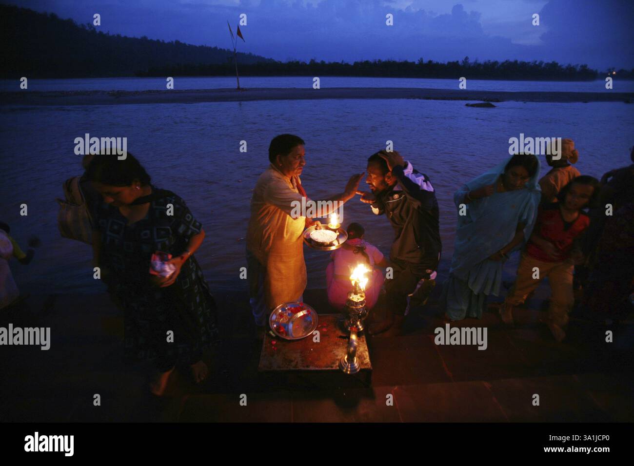 Devotees making the holy evening prayers of the Ganga River on the river banks at Rishikesh in Uttaranchal, India, Asia Stock Photo
