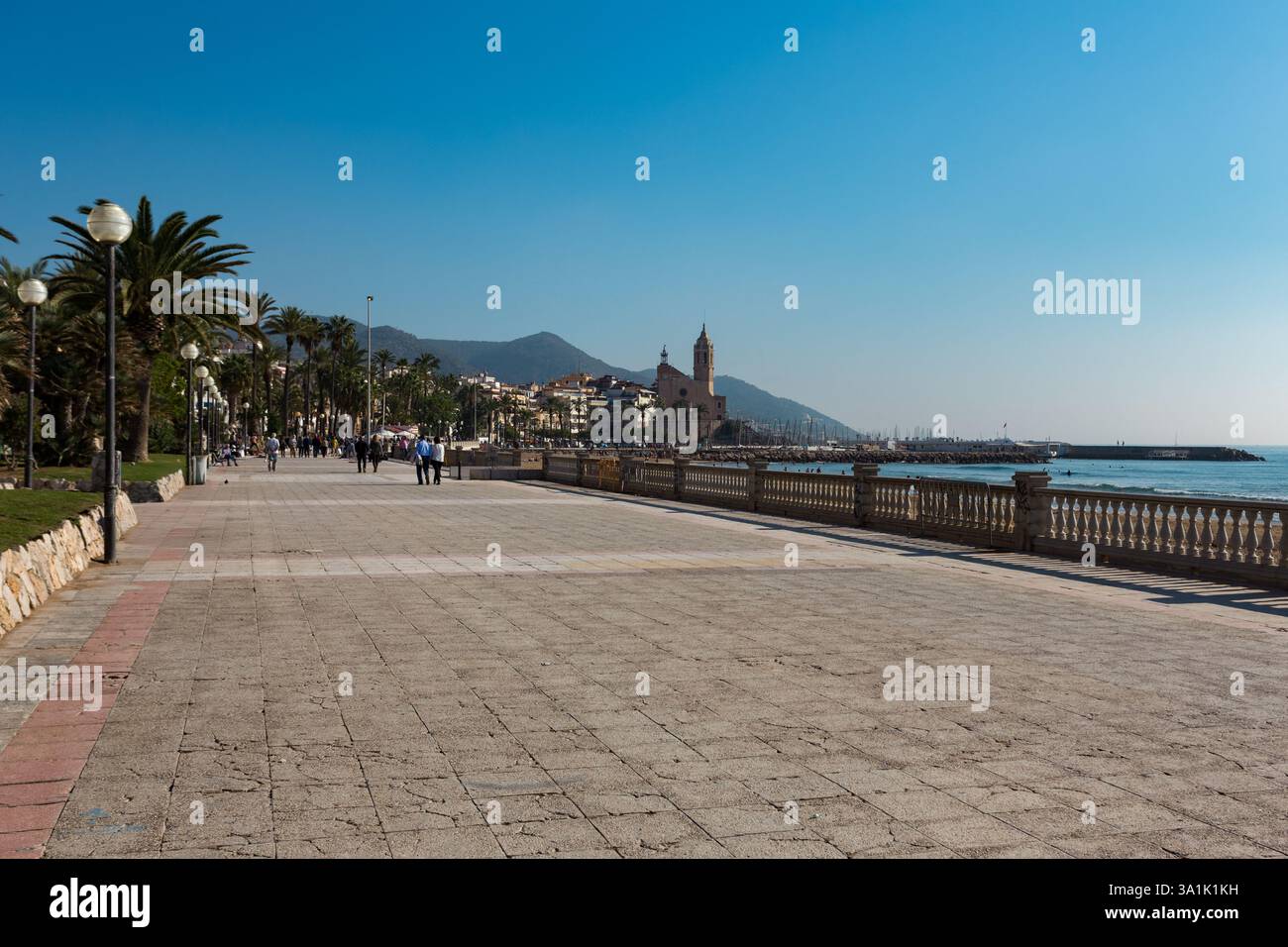 Famous promenade in Sitges, Spain, with palm trees and historic ...